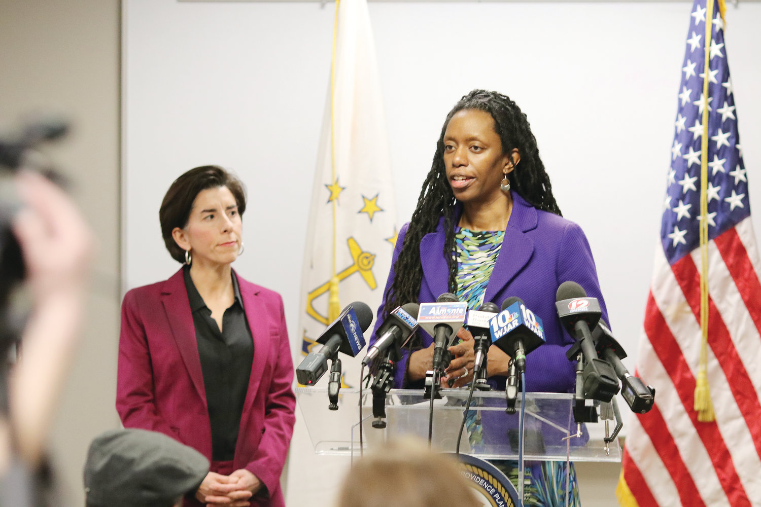 At a press conference at the Department of Administration, held March 9, Dr. Nicole Alexander-Scott, Rhode Island Director of Health, shares ways to keep nursing home residents safe from coronavirus. At the conference, Governor Gina Raimondo, at left, officially declared a state of emergency over the virus.